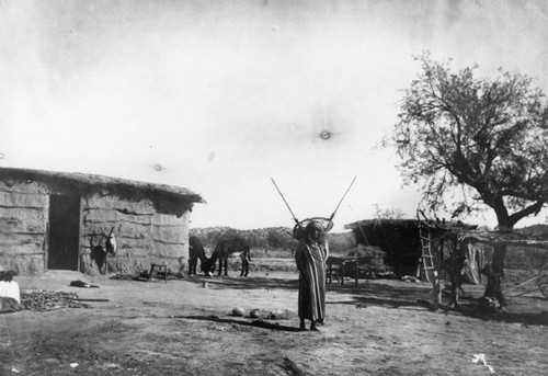 American Indian wearing a burden basket