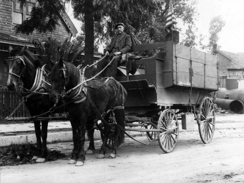 Joe Marikian in a horse-drawn cart