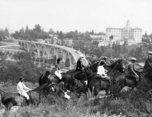 Horseback riders overlooking the bridge