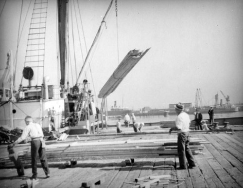 Loading stacks of lumber at Los Angeles Harbor