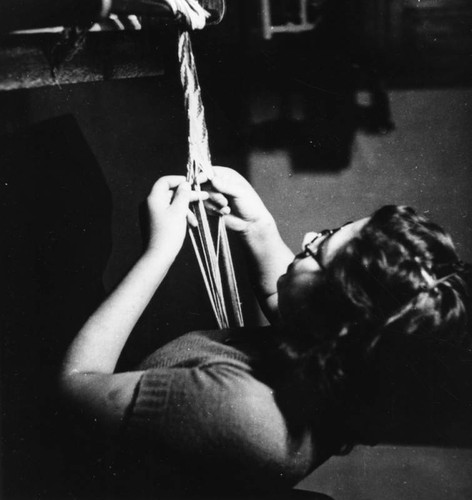 American Indian girl weaving belt