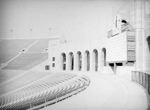 Coliseum arched entrance, timer, scoreboard and bleachers