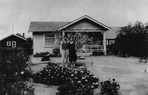 Mexican American couple in front of house