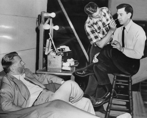 Jack Webb gets a "black eye" from make-up man