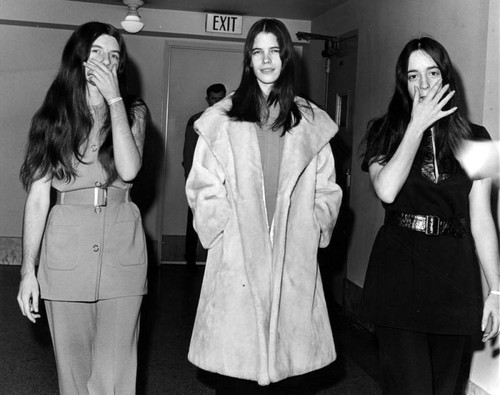 Three female defendants on their way to court