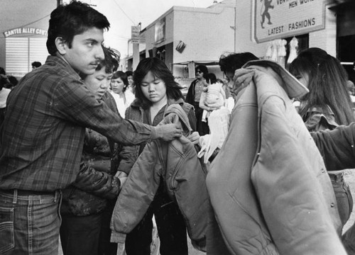 Christmas shoppers haggle on Santee Street Alley