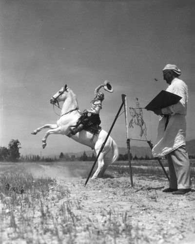 Artist painting horse and rider