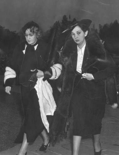 Actress Patsy Kelly (shown on the right) arrives with a friend to attend Thelma Todd's funeral. Ms. Kelly was in Miss Todd's most recent comedy film.