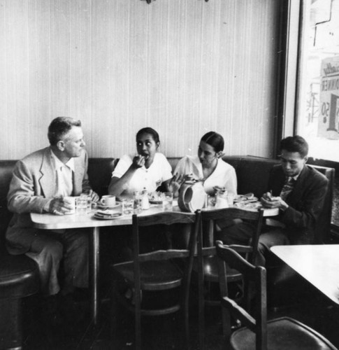 Four people having lunch in a diner