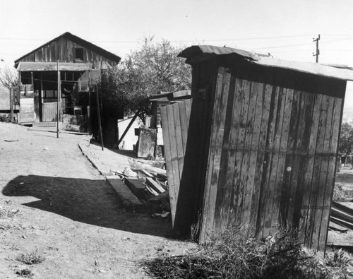 View of a slum home and outhouse