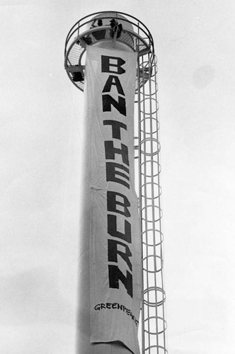 Demonstrators unfurl banner on smokestack