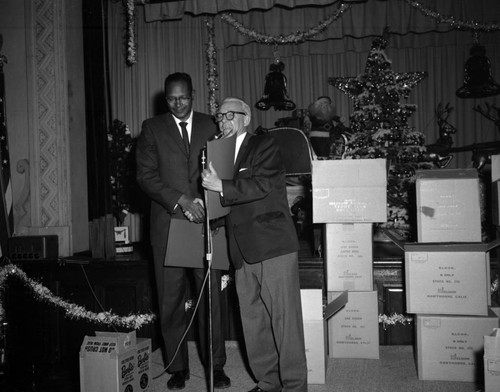 Councilmember Tom Bradley presenting a resolution to unidentified man