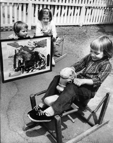 Heidi rides on rocking horse, friends wonder about painting