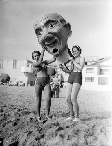 Girls with giant Mardi Gras head