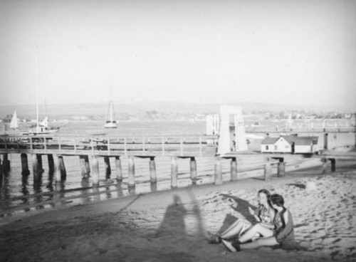 Sitting by a pier at Balboa Beach