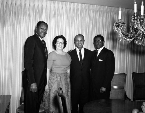 Councilman Tom Bradley and Gloria Curtis with group at a party