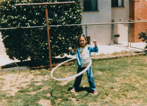 Girl playing with hoop toy