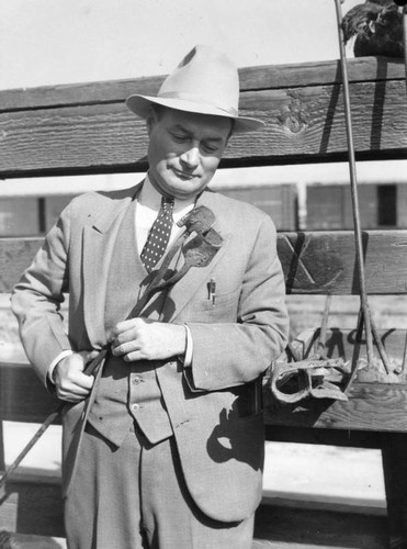 Man in a suit with a branding iron