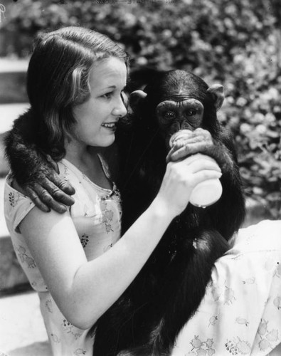 Woman feeding monkey