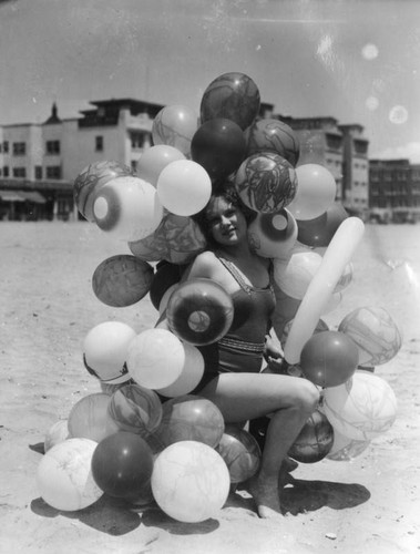 Woman at the beach with balloons