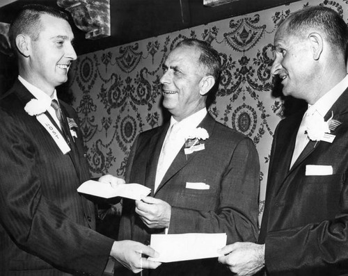 T. F. Dixon, right, and S. K. Hoffman, center, receive awards