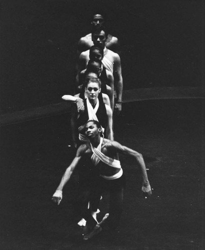 Dancers stand posed on stage