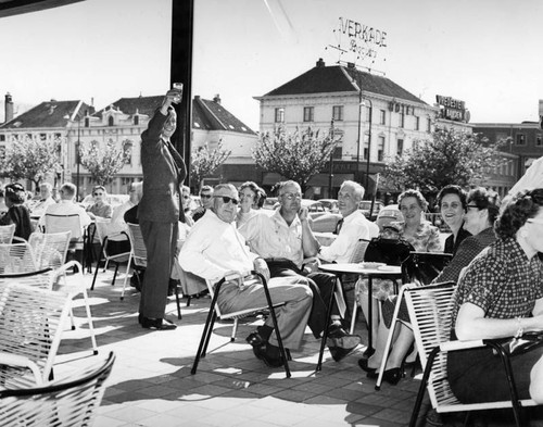 Tourists lunch at sidewalk cafe