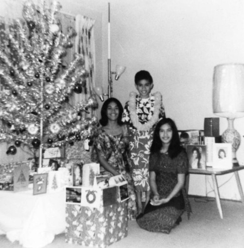 Family beside Christmas tree