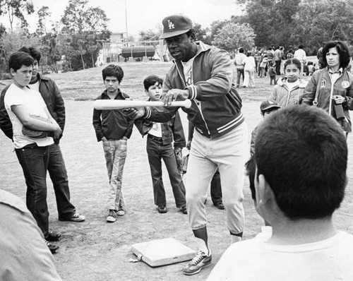 Gilliam shows boys how to bunt