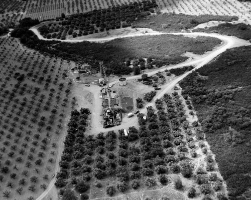 Closeup view, oil derrick on farm land