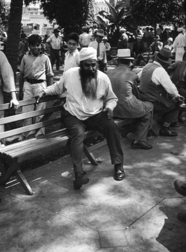 Indian man on bench at L.A. Plaza park