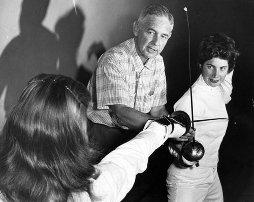 Fencing coach John Tatum gives instruction