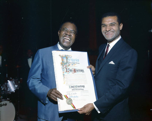 Louis Armstrong is presented with a resolution