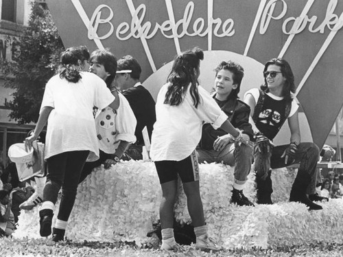 Fans climb on Menudo float