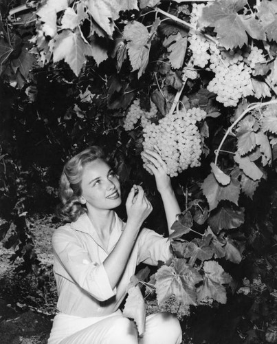 Woman posing with grapes