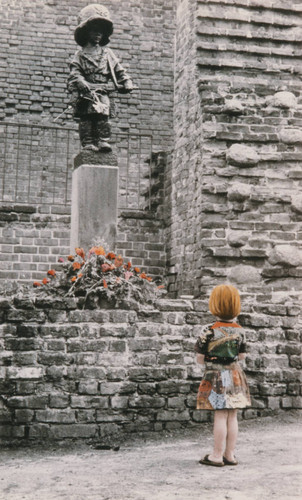 Child viewing The Little Insurgent Monument in Warsaw, Poland