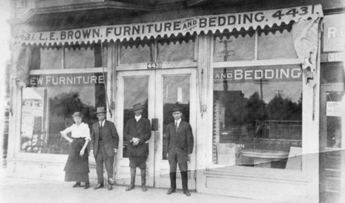 L.E. Brown and wife in front of store