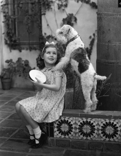 Small girl with a dog, view 1