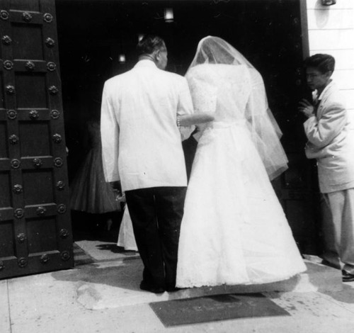 Natividad and father entering church