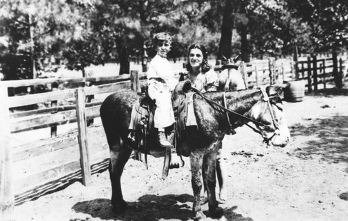 Boy riding pony