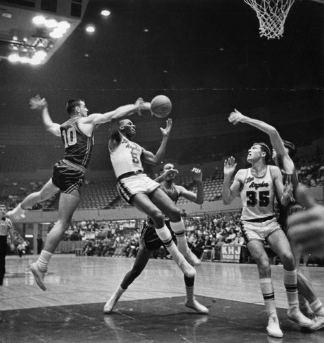 Dick Barnett (5) of the Lakers battles for the ball with New York's Dave Budd (10)