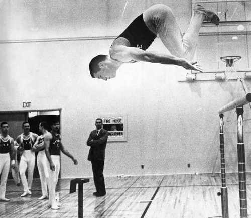 Rusty Rock in mid-air off the high bar