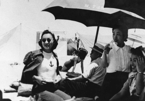 Women at the beach under umbrellas