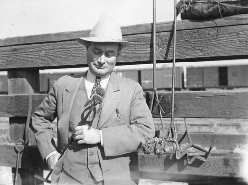 Man in a suit with a branding iron