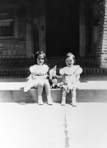 Two girls with clown doll