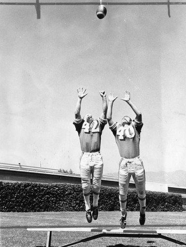 Burroughs High players leap for ball in practice