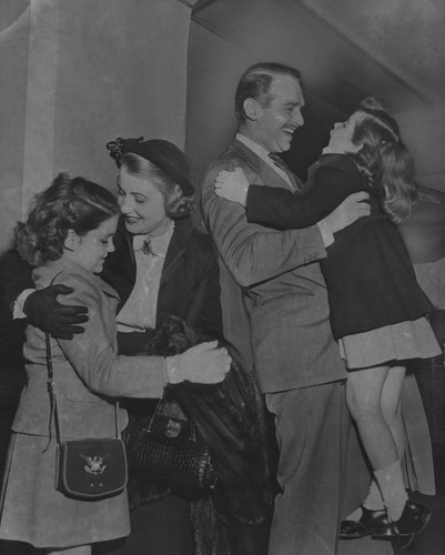 Mary Lee and Douglas Fairbanks Jr. greet their children at Union Station