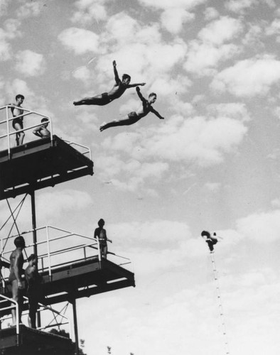 Divers performing off platform