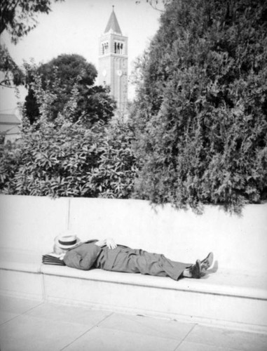 Sleeping on a bench in front of Mudd Hall at U.S.C