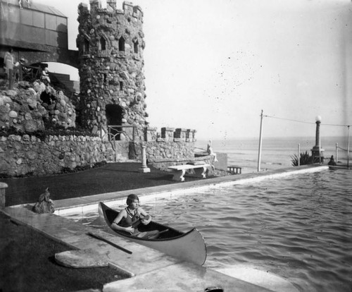 Woman in a canoe playing a ukulele